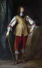 The painting shows a young looking Prince Rupert standing upright, wearing smart court clothes and a large waistcoat. His hair is long, black and curled. He is holding a cane in one hand and looks proud.
